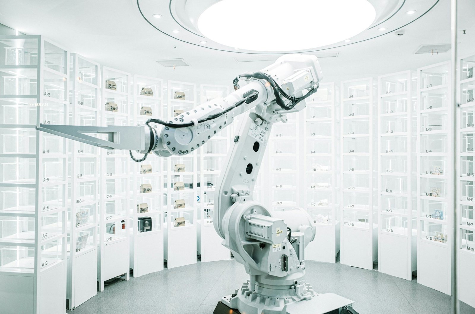 An industrial robot arm in a bright white room