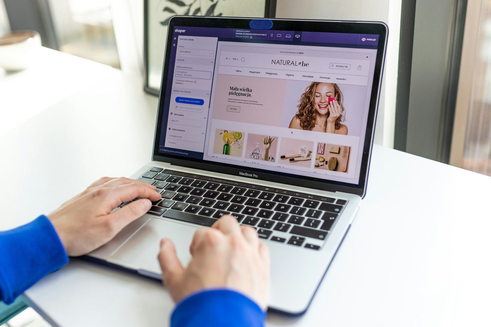A person editing an ecommerce storefront on a laptop