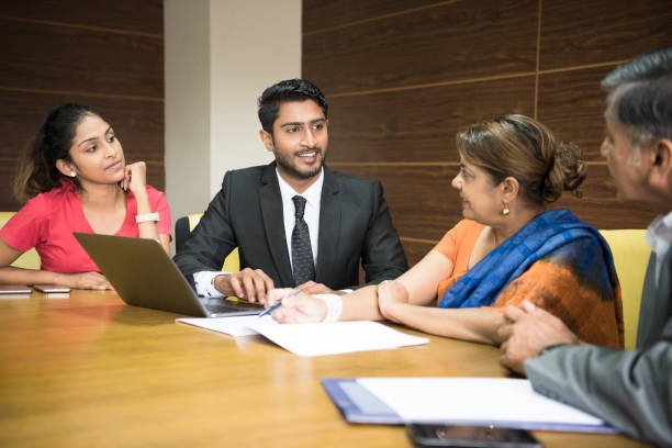 A leadership team reviewing a plan around a meeting table