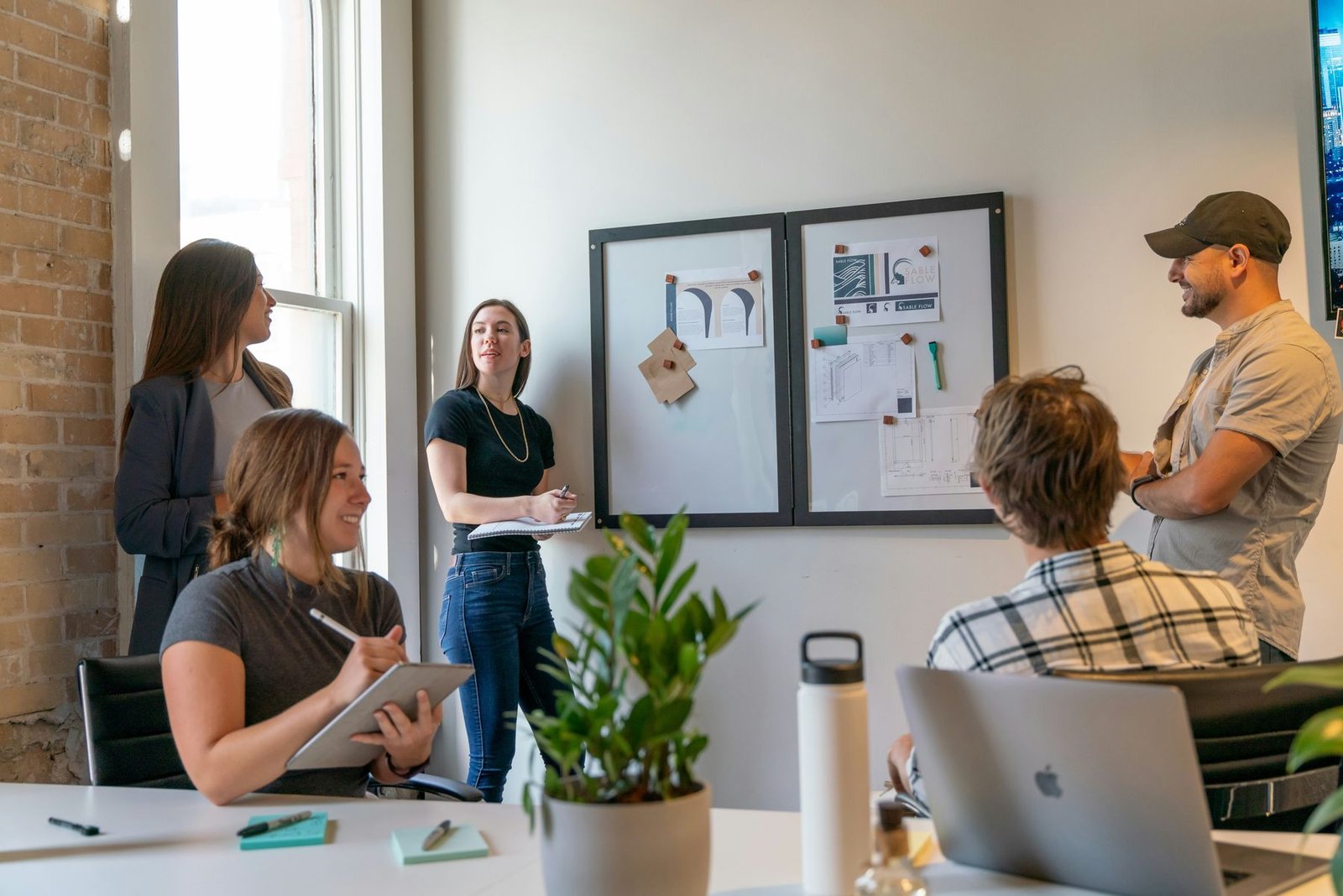 A team reviewing brand work pinned to a board